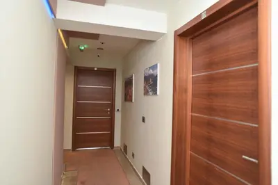 a hallway with a wooden door in a house at Omega 4 Apartment in Budva