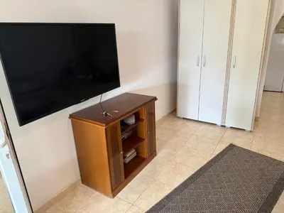 a living room with a flat screen tv on a wall at Stuart Žukotrlica in Bar