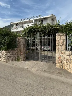 a gate in front of a house with a building at Stuart Žukotrlica in Bar