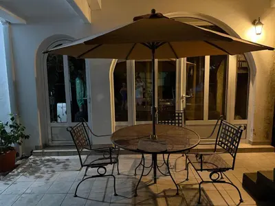 a table and chairs with an umbrella on a patio at Stuart Žukotrlica in Bar