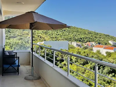 an umbrella sitting on a balcony with a view at GlamSea in Bar