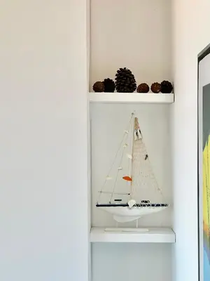 a shelf with a model of a boat on it at GlamSea in Bar