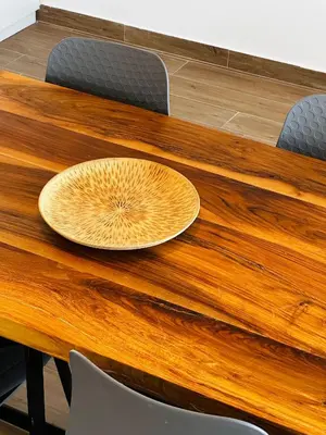 a wooden table with a plate on top of it at GlamSea in Bar