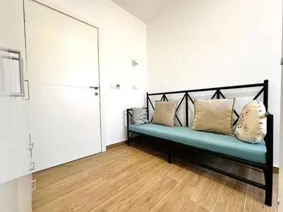 a room with a bench with pillows on it at GlamSea in Bar
