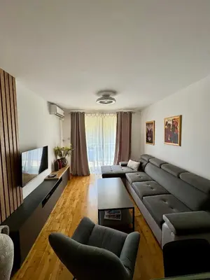 a living room with a couch and a flat screen tv at Infinity Apartment Blue Horizont Przno in Kravlja