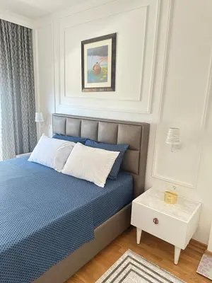 a bedroom with a bed with a blue comforter at Lux apartman sa garažom in Budva