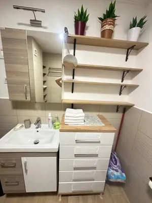 a bathroom with a sink and a mirror at Lux apartman sa garažom in Budva