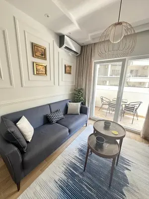 a living room with a blue couch and a table at Lux apartman sa garažom in Budva