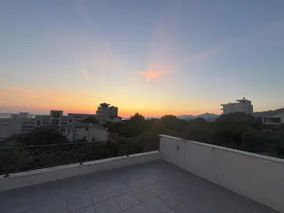 a view of the sunset from the balcony of a building at Villa Diel 300m vom Strand in Utjeha