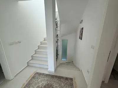 a white staircase with a rug on the floor at Villa Diel 300m vom Strand in Utjeha