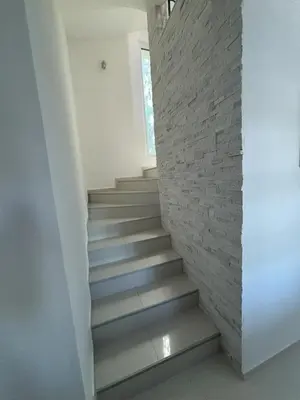 a staircase in a house with a brick wall at Villa Diel 300m vom Strand in Utjeha