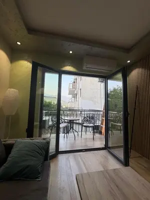 a living room with a view of a balcony at Kasia in Kravlja