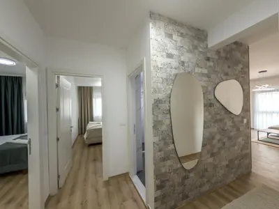 a room with a stone wall with a mirror at Amarea Apartments in Ulcinj