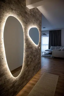 a living room with a stone wall with a mirror at Amarea Apartments in Ulcinj