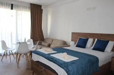 a hotel room with a bed with towels on it at AMD - studio104 in Dobra Voda