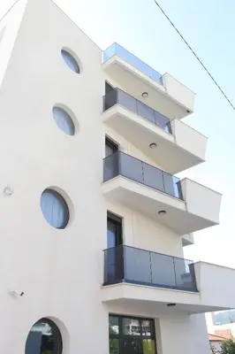 a building with balconies on the side of it at AMD - studio104 in Dobra Voda