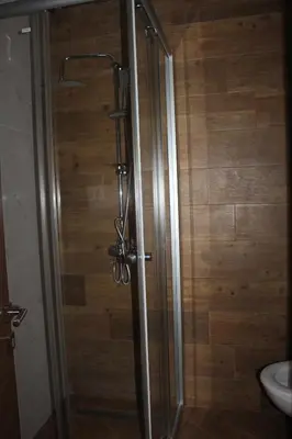 a shower with a glass door in a bathroom at AMD - studio104 in Dobra Voda