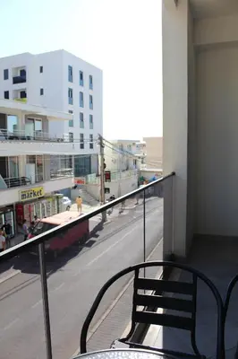 a balcony with a chair and a city street at AMD - studio104 in Dobra Voda