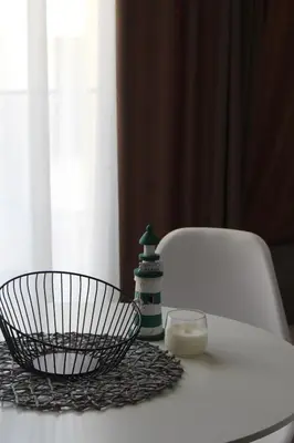 a white table with a bowl and a candle on it at AMD - studio104 in Dobra Voda