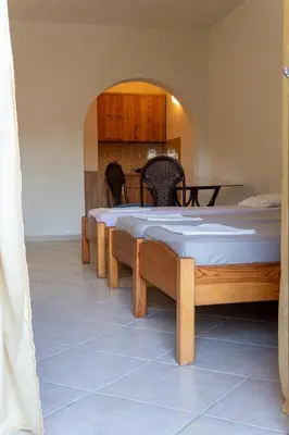 a room with a bed and a table and chairs at Apartments Noki in Ulcinj