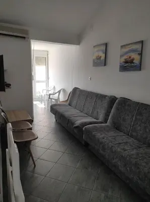 a living room with a couch and a table at Apartment Vidakovic in Budva