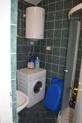 a bathroom with a washing machine and a washer at Apartment Vidakovic in Budva