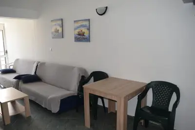 a living room with a couch and a table at Apartment Vidakovic in Budva