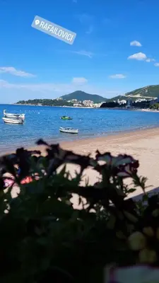 a view of a beach with boats in the water at Apartment Vidakovic in Budva