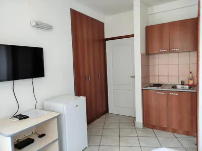 a small kitchen with a sink and a refrigerator at Guest House Violet in Becici