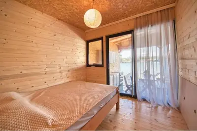 a bedroom with a bed in a room with a window at Sunset 4 in Ada