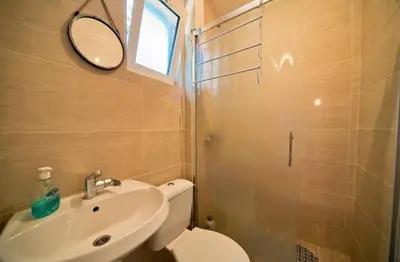 a bathroom with a toilet and a sink and a mirror at Sunset 4 in Ada