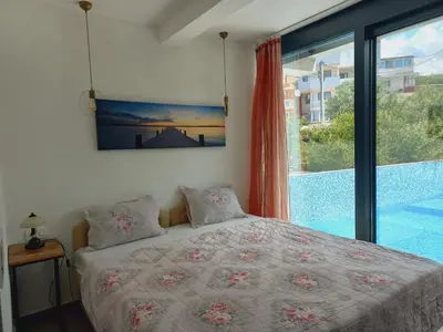 a bedroom with a bed and a large window at Villa Nuna in Bar