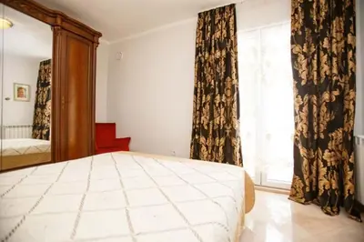 a bedroom with a large bed and a mirror at Villa Nuna in Bar