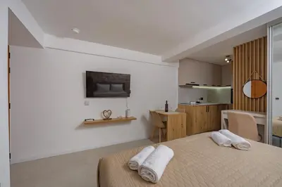 a bedroom with two white towels on a bed at Apartments Račić in Kotor