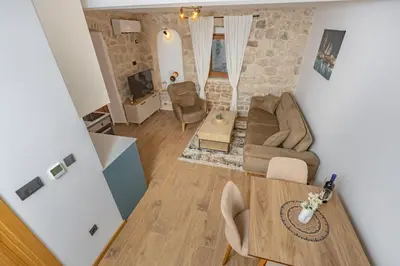 a living room with a couch and a table at Apartments Račić in Kotor