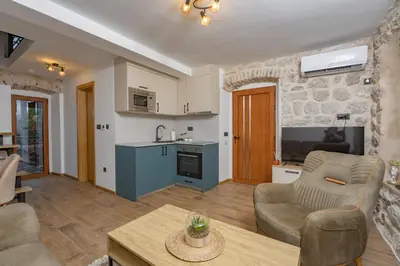 a living room with a couch and a table at Apartments Račić in Kotor