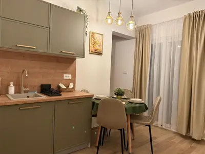 a kitchen and dining room with a table and chairs at Apartmani Stefanos - Jaz in Budva