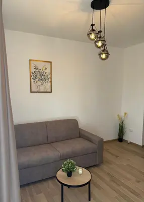 a living room with a couch and a table at Apartmani Stefanos - Jaz in Budva