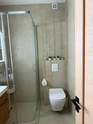 a bathroom with a toilet and a glass shower at Apartmani Stefanos - Jaz in Budva