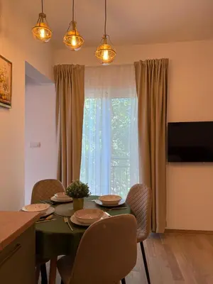 a dining room with a table with chairs and a window at Apartmani Stefanos - Jaz in Budva