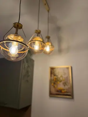 a group of lights hanging from a wall with a picture at Apartmani Stefanos - Jaz in Budva