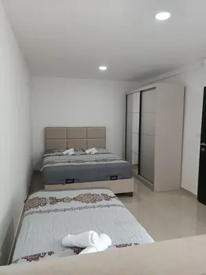 two beds in a room with white walls at Vila Eden in Bar