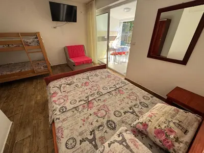 a room with a bed and a rug on the floor at Apartments TRI SRCA in Sutomore