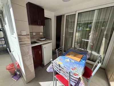 a small kitchen with a table in the middle of it at Apartments TRI SRCA in Sutomore
