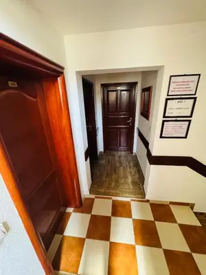 a hallway with a door and a checkered floor at Apartments TRI SRCA in Sutomore