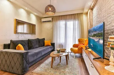 a living room with a couch and a tv at Bar- Apartment Prestige in Bjeliši