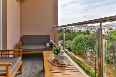 a balcony with a chair and a table with a view at Bar- Apartment Prestige in Bjeliši
