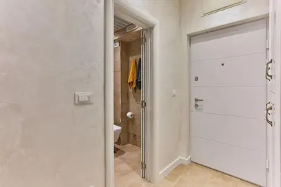 a bathroom with a door leading to a shower at Bar- Apartment Prestige in Bjeliši