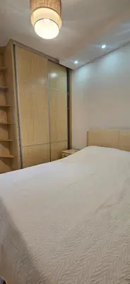 a bedroom with a large bed and a closet at Seaside Port Apartments in Bar