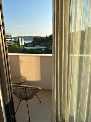 a view of a balcony with a chair and a window at Kuc-kuc Twin towers in Becici